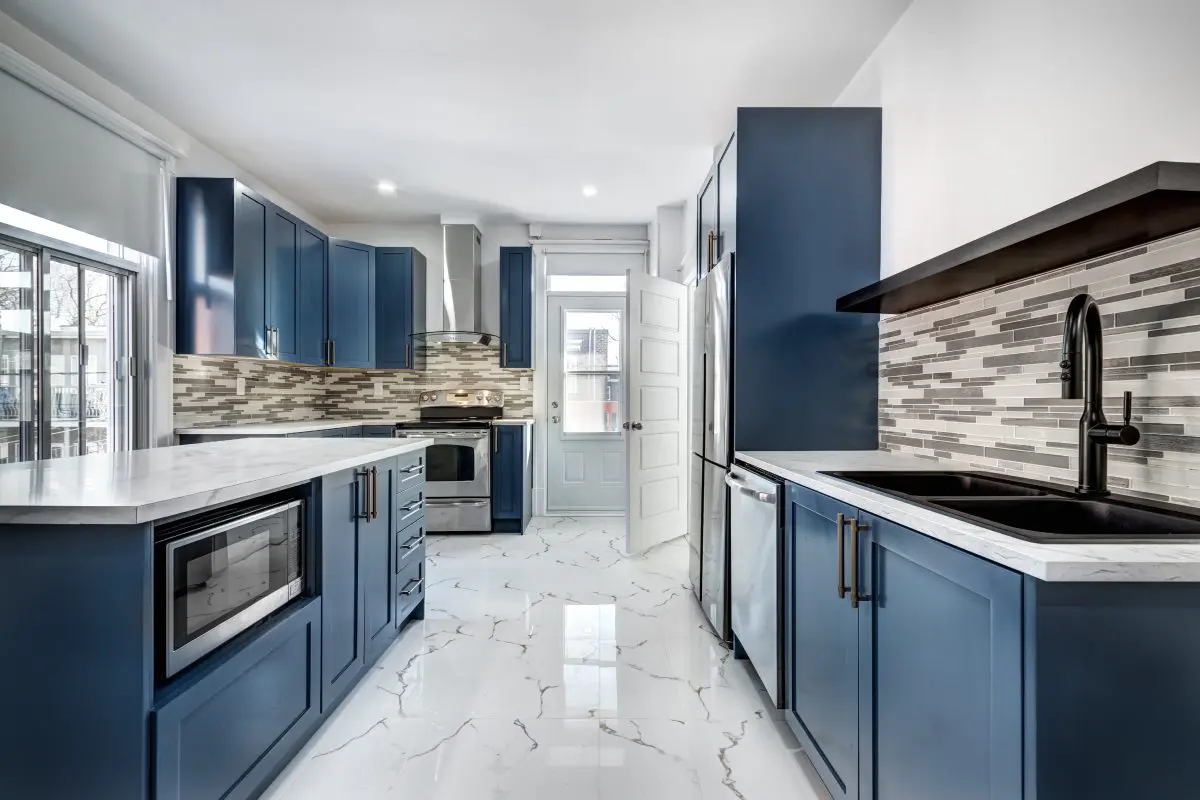 Modern kitchen with blue cabinets and appliances.