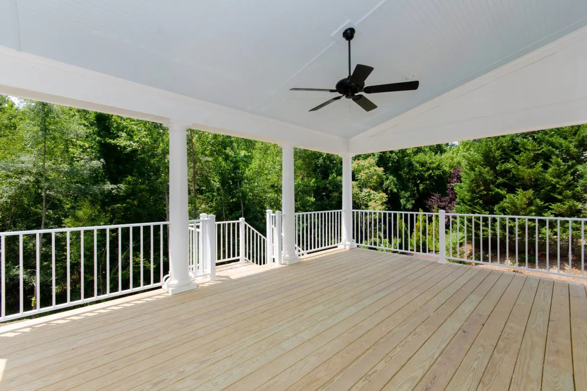 Spacious outdoor deck with ceiling fan.