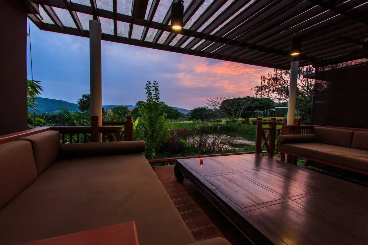 Covered patio with scenic evening view.